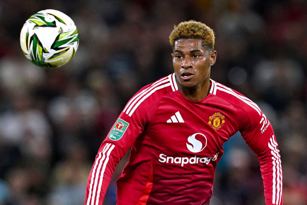 Marcus Rashford corre in campo con il pallone durante una partita con il Manchester United